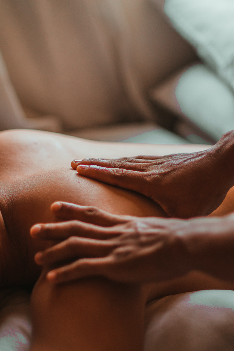 Close-up shot of two individuals: one person is giving a massage to the other.